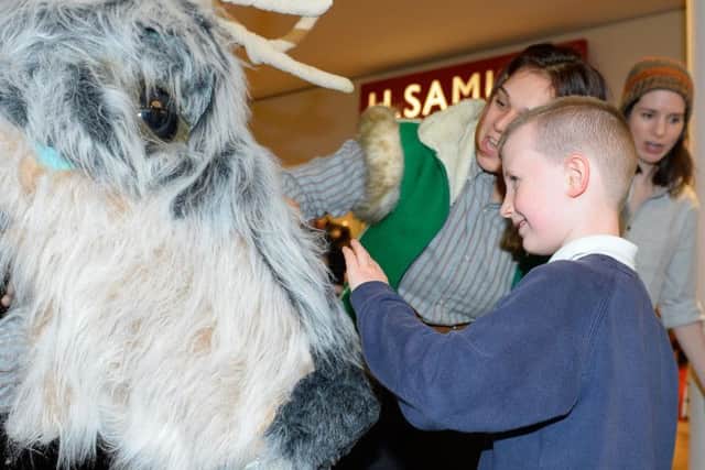 Families getting up close with the 7ft reindeer puppet at Meadowhall