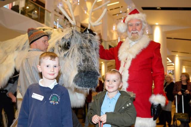 Santa and his helper with the magical puppet reindeer and young fans at Meadowhall