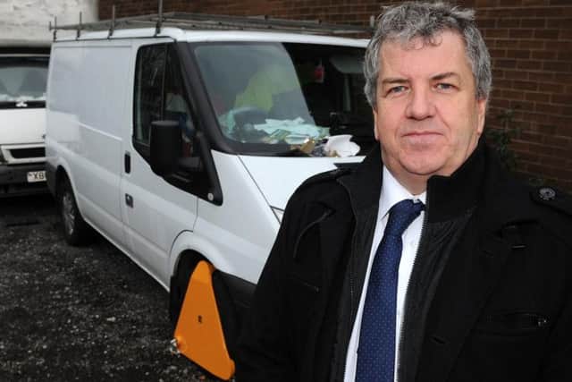 Bryan Lodge with two vans which have been impounded over suspected fly-tipping