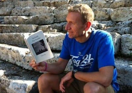 Pictured is reporter Jon Cooper reading Sue Day's novel The Roads They Travelled.