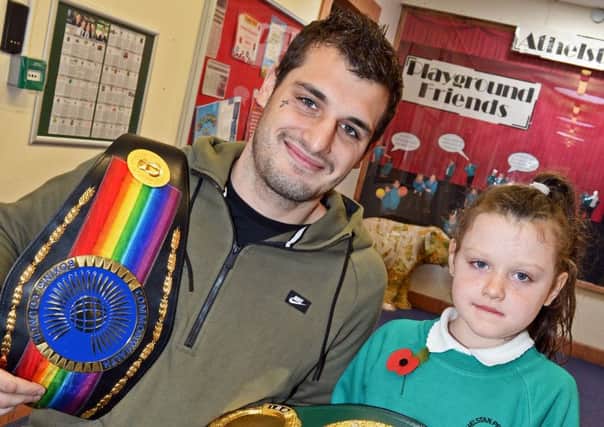 Commonwealth boxing champion Liam Cameron pictured with his daughter India, six, during his visit to Athelstan Primary School. Picture: Marie Caley
