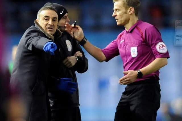 Carlos Carvalhal gets a talking to from referee Michael Jones