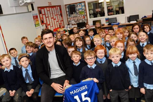 Maguire, pictured with year one and two children at Immaculate Conception Catholic Primary School in Spinkhill. Picture: Marie Caley/The Star
