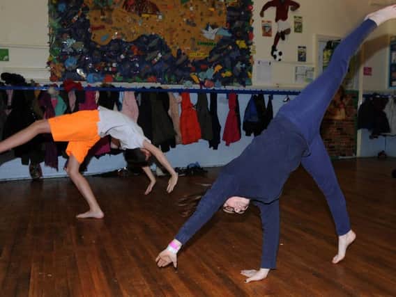 Year 6 pupils Harrison and Elena, of Malin Bridge Primary School do gymnastics in their PE lesson