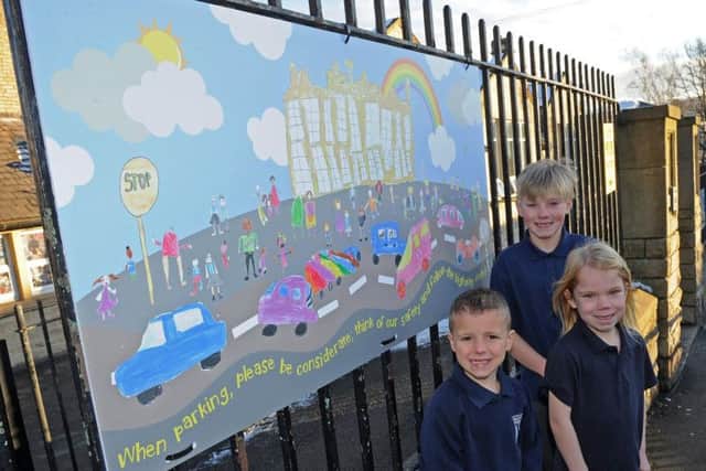 Year 6 pupil Elliot and year 1 pupils Leo and Lexi, of Malin Bridge Primary School helped create the schools road safety sign