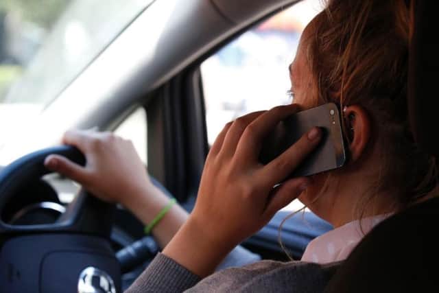 A driver using their mobile phone.