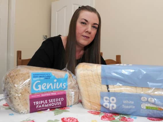 Celiac suffer Camilla Sherwin with her smaller 2.80 gluten-free load and her husband's larger regular loaf at 79 pence. Picture: Andrew Roe/The Star