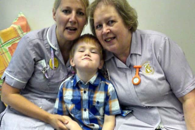 William with nurses at the end of his treatment