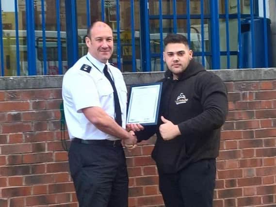 Chief Insp Ferguson presenting Martin with his commendation.