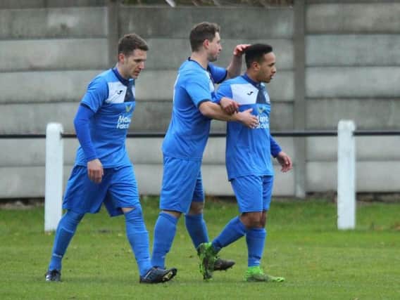 Hat-trick hero Luke Williams is congratulated after giving Armthorpe the lead against Retford United. Pic: Steve Pennock