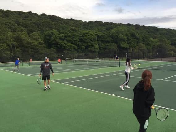A coaching session on the tennis courts at Millhouses Park