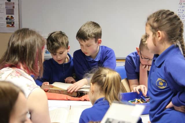 Pupils pictured working with Rebecca Sheldon from Derbyshire Records Office