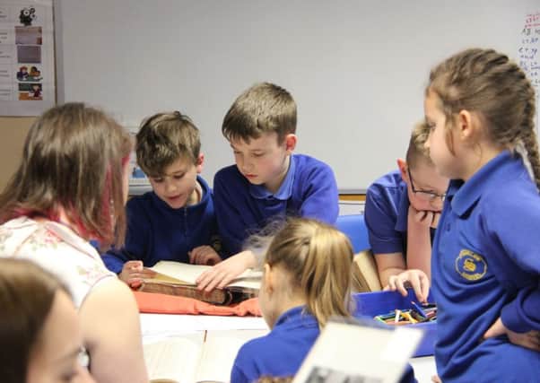 Pupils pictured working with Rebecca Sheldon from Derbyshire Records Office