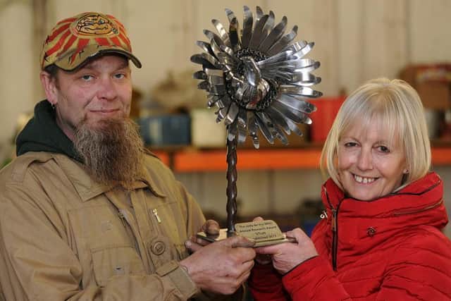 Artist Richard Heppenstall and Jude with the award created in her son's memory