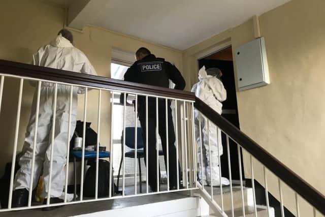 Forensic officers at the scene after a woman was found dead inside a flat on Hazelbarrow Crescent in Jordanthorpe. Picture: George Torr/The Star