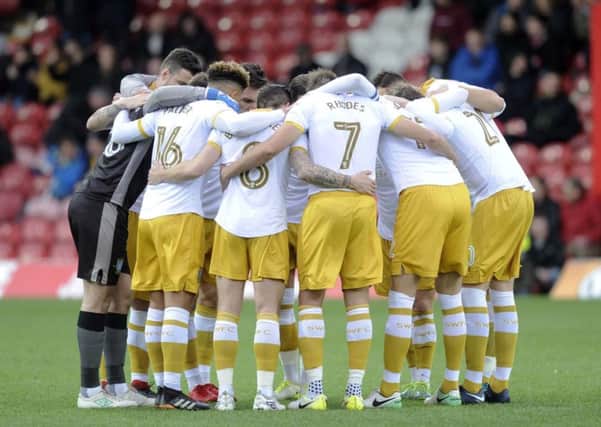Owls players in a huddle at Griffin Park on Saturday......Pic Steve Ellis