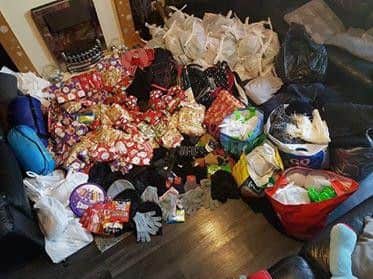 The haul of gifts for homeless people this year takes up most of the family's living room