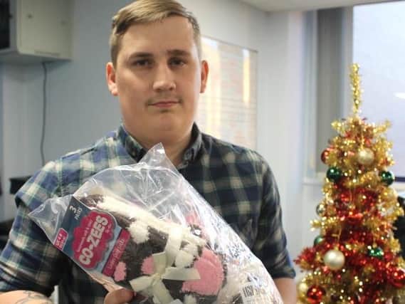 A team member receiving fluffy socks, scarves and gloves for young people in contact with Sheffield Future's sexual exploitation service