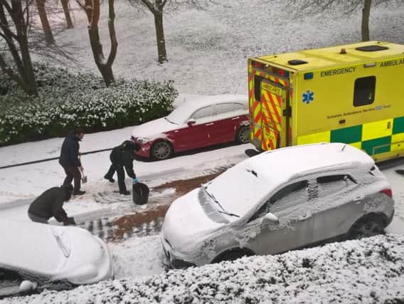 Residents help to dig out an ambulance in Walkley.