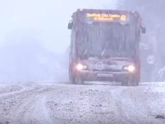 A bus makes its way through the morning snow