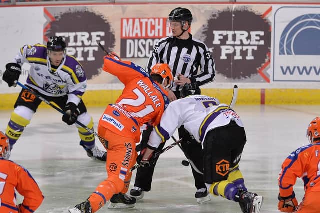 Tim Wallace contests the puck against Manchester Storm