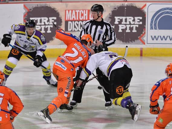 Tim Wallace contests the puck against Manchester Storm