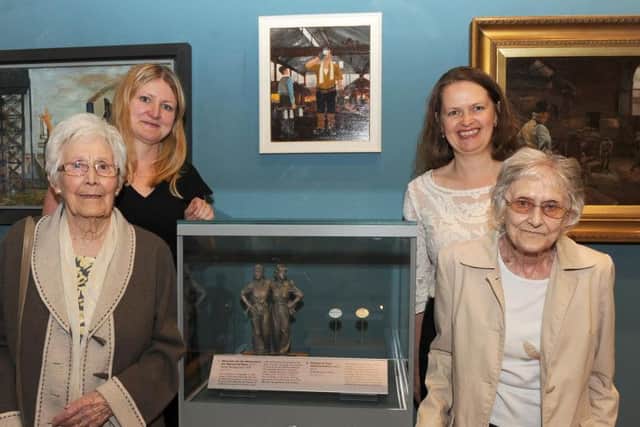Kit Sollitt and Kathleen Roberts with Nancy Fielder and Kim Streets beside the Women of Steel maquette at the Weston Park Museum.