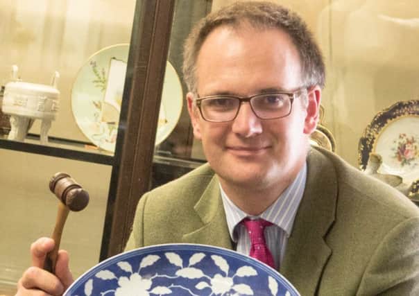 Charles Hanson, owner of Derbyshires Hansons Auctioneers, with a Chinese plate.