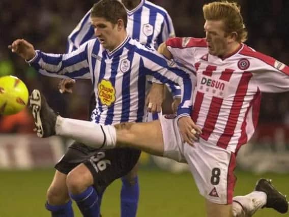 Stuart McCall sticks a foot in against Carl Robinson
