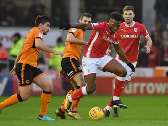 Barnsley's Andy Yiadom gets away from two Wolves players during the 0-0 draw at Oakwell. Pic: Press Association