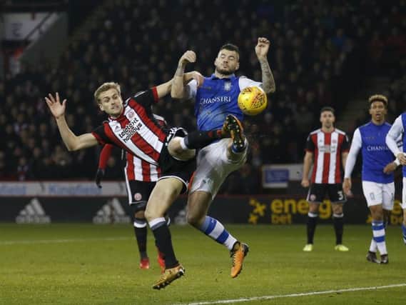 Sheffield Wednesday's Daniel Pudil battles for possession with Sheffield United's James Wilson.