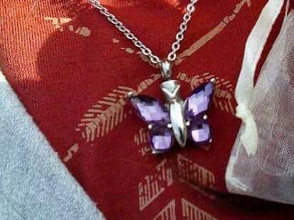 Roseann's butterfly necklace, which contains her late mother's ashes