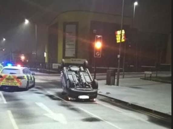 A car landed on its roof in the snow last night