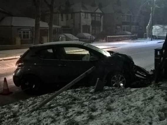 A car crashed into a lamppost in the snow in Norton, Sheffield