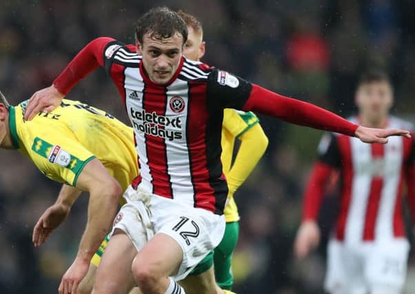 James Wilson of Sheffield Utd challenges Christoph Zimmermann of Norwich City during the Championship match at Carrow Road. Simon Bellis/Sportimage
