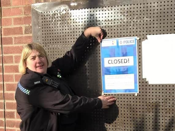 PC Lisa Ainsworth fixes the closure notice to the bungalow (photo: South Yorkshire Police)