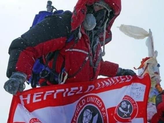 Ian planted a Sheffield United flag at the summit to boost his fundraising total, despite being a devoted Owls fan