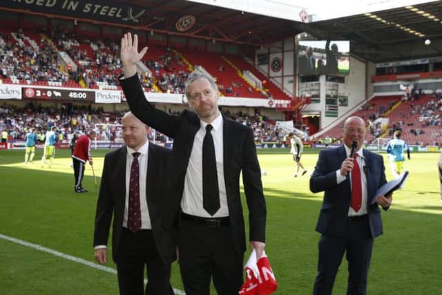 Ian returns the flag to Bramall Lane after completing his amazing achievement