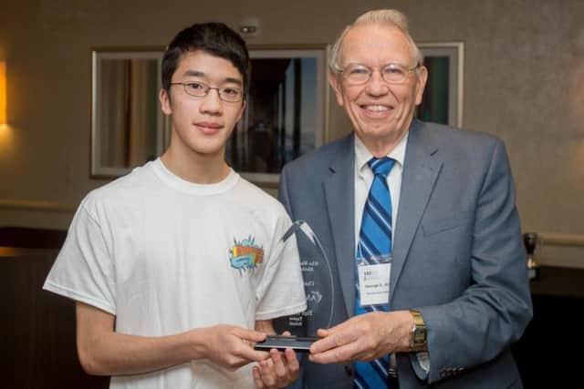 Yuji receives an award from George Andrews, former president of the American Mathematical Society