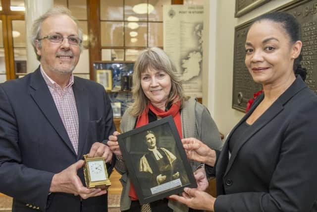 Ian and Sarah Brown present their grandfather's old clock to headteacher Linda Gooden