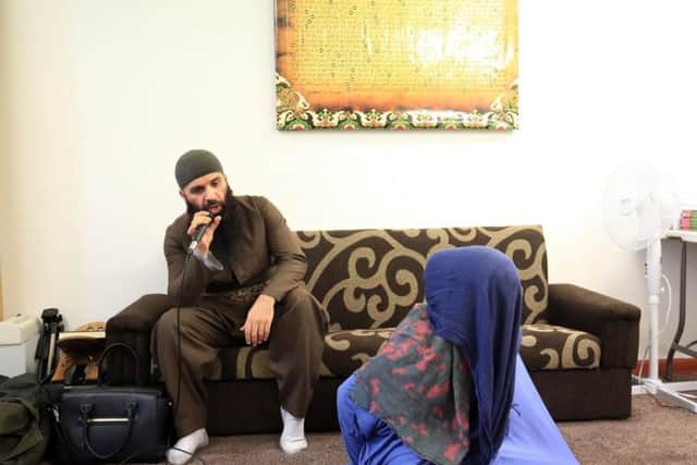 Imam Ayoub performs the exorcism.