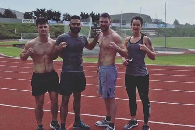 Boxer Anthony Tomlinson second left with his training team