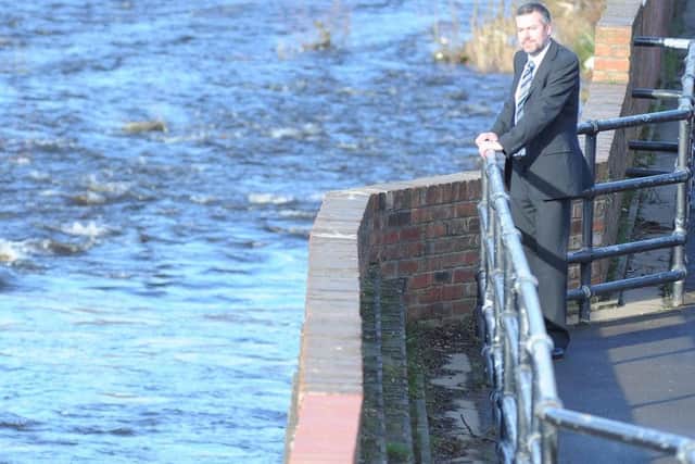 Andy Segrott, of Sheffield Forgemasters, inspects the new flood defences along the Lower Don Valley