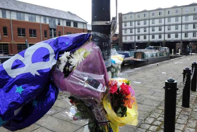 Flowers left at Victoria Quays in tribute to Alex Wilson.
