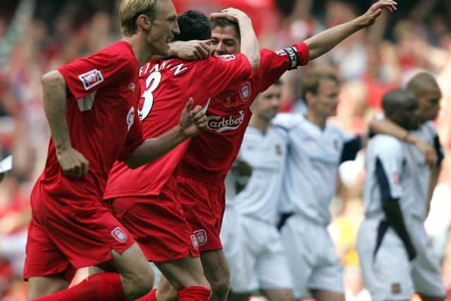 Liverpool's Steve Finnan and Steven Gerrard embrace after victory in the penalty shoot-out as West Ham United players stand dejected at the FA Cup final at the Millennium Stadium in 2006