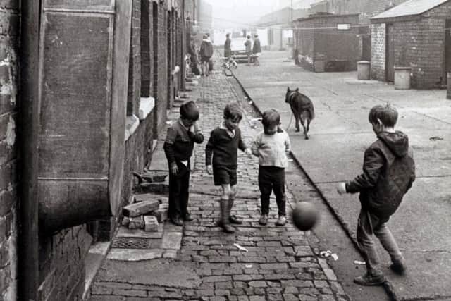Children play football lin the street
