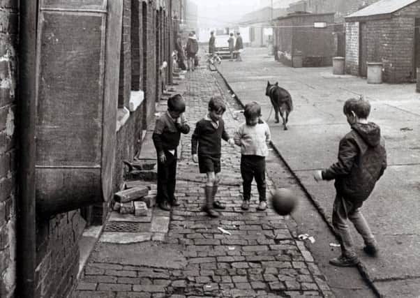 Children play football lin the street