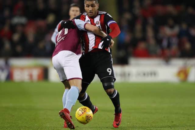 Leon Clarke gets stuck in against Aston Villa: Simon Bellis/Sportimage