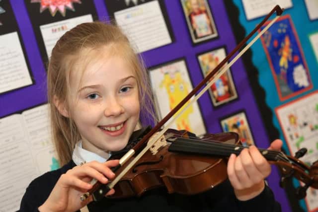 Emily Roberts, nine, who plays the violin