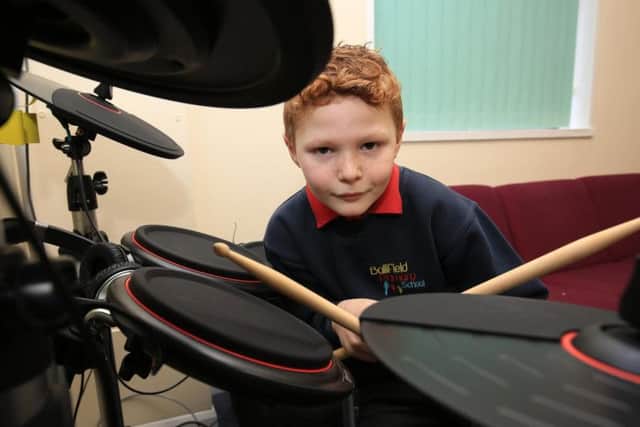 Ruban Jenkinson, eight, playing the drums